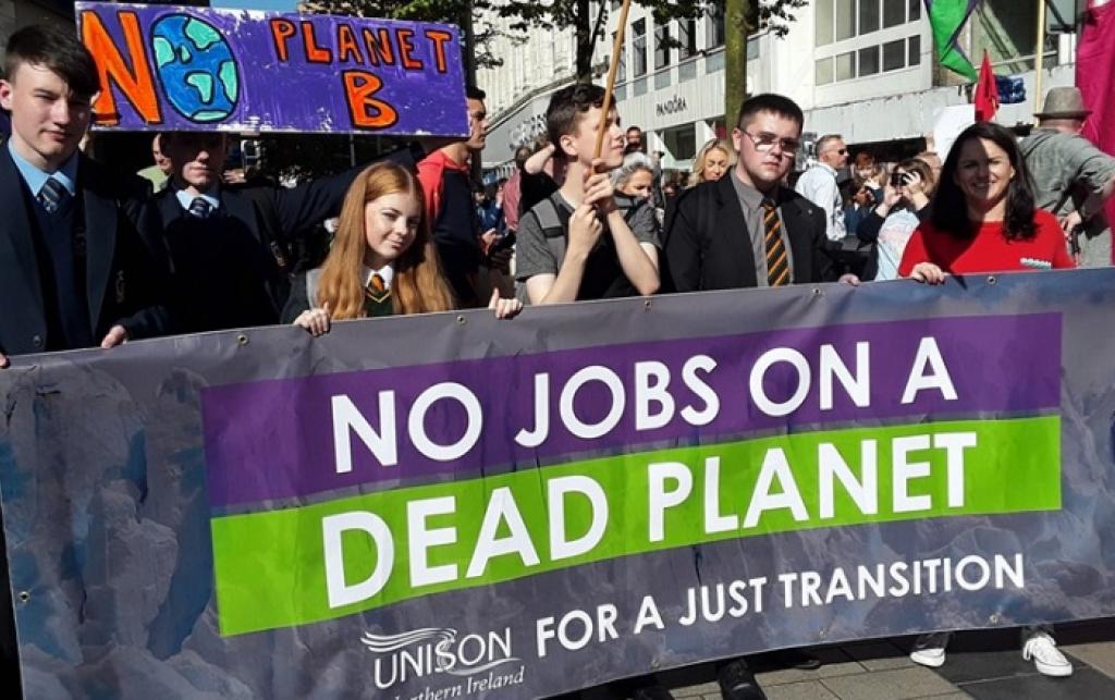 Workers’ rights campaigners and trade unionists marching in London to demand a just transition to renewable energy.