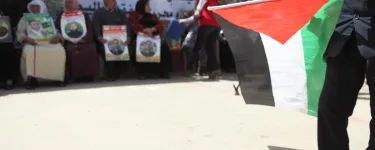 Palestinian prisoner solidarity demonstration with a Palestinian flag in the foreground. Credit: War on Want/Rich Wiles