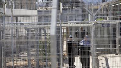 Palestinians walk through the gates of Ofer Military Court and Prison. Photo: Oren Ziv/Activestills