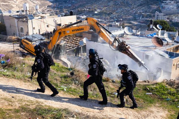Israeli soldiers overseeing the demolition of homes in East Jerusalem