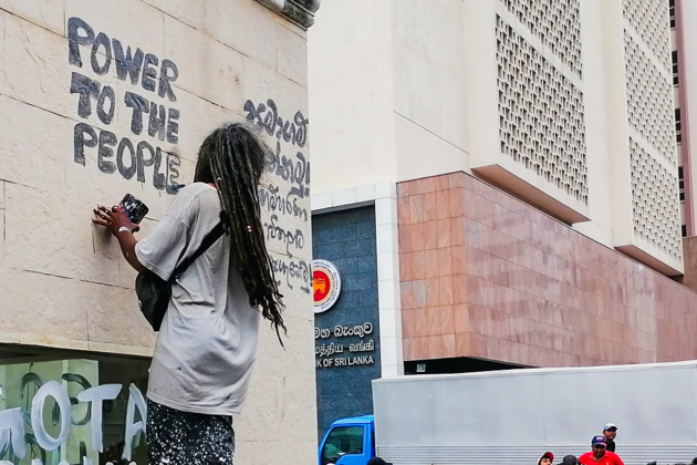 Sri Lanka protestor graffitis 'power to the people'