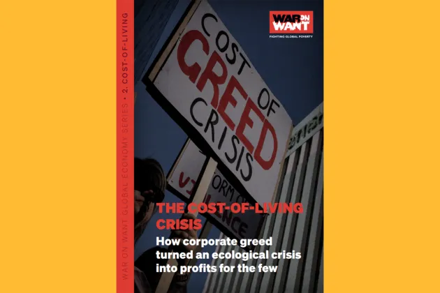 Report front page which shows a person holding a sign at a protest.