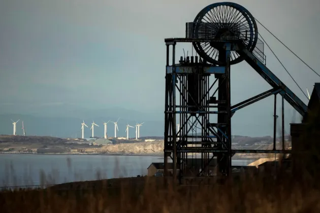 Black machinery, windfarm in background