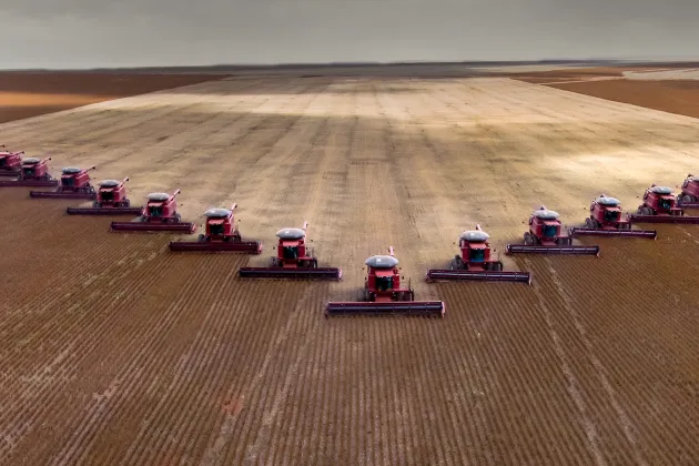 A field with lots of tractors lined up on it