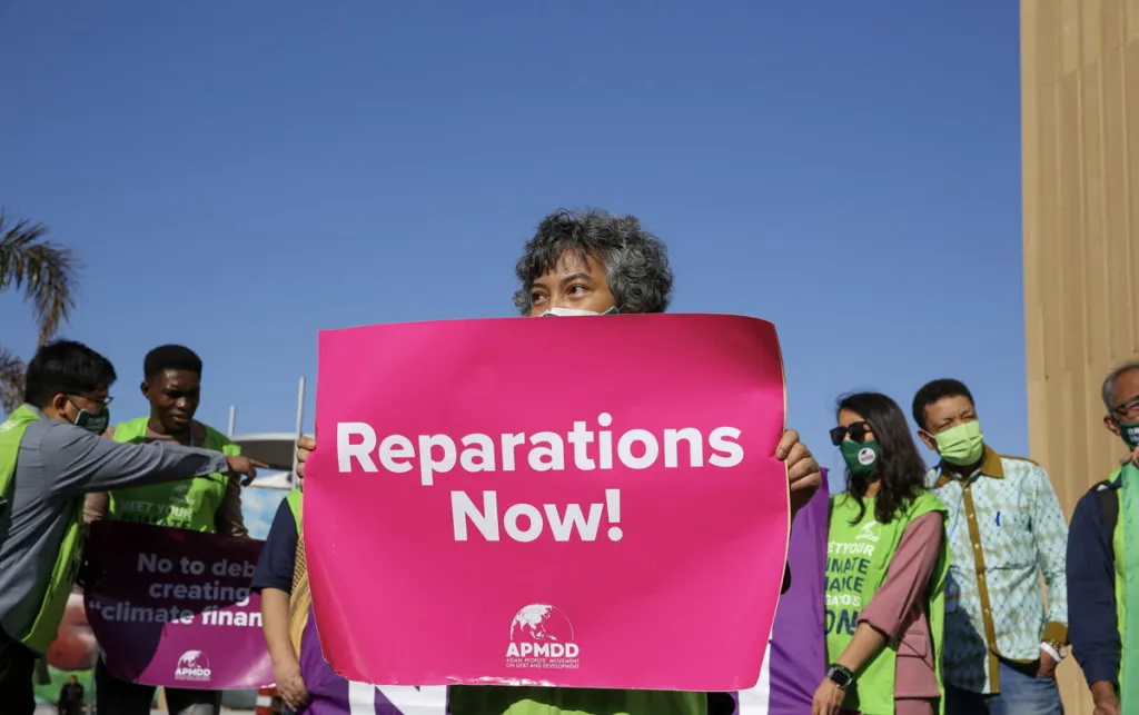 A climate justice campaigner elevates the APPMD call for climate reparations at COP27 climate conference in Egypt, November 2022.