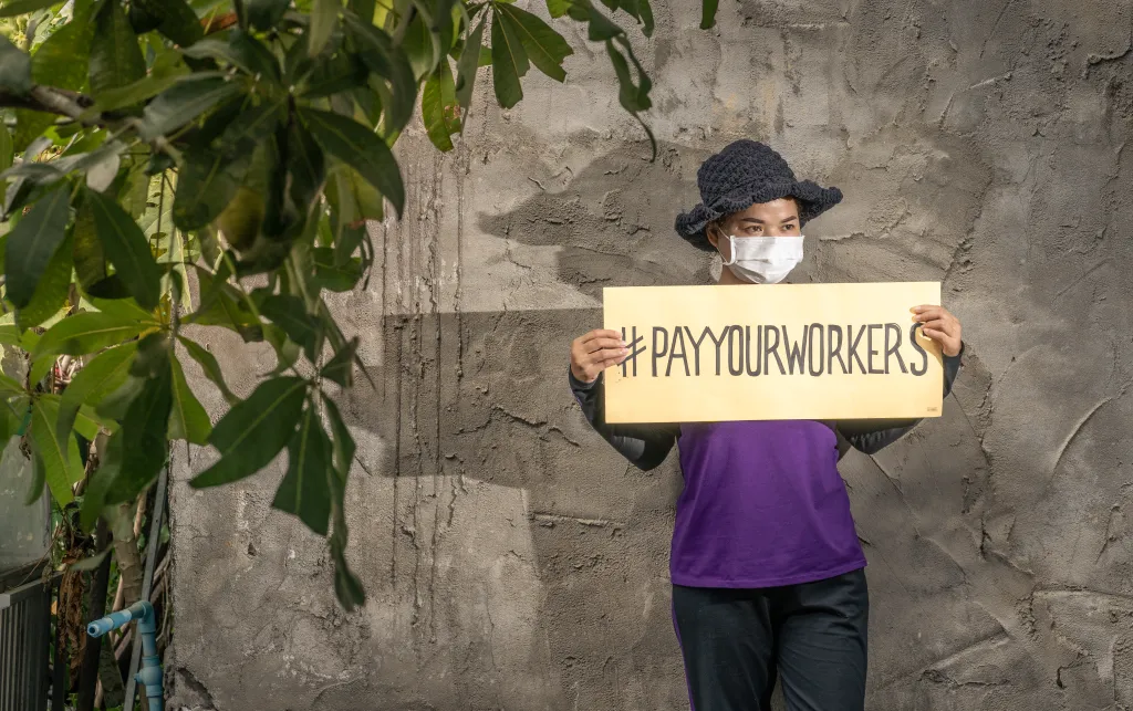 Garment worker in Cambodia protesting high street brands to demand full wages and severance during the pandemic.