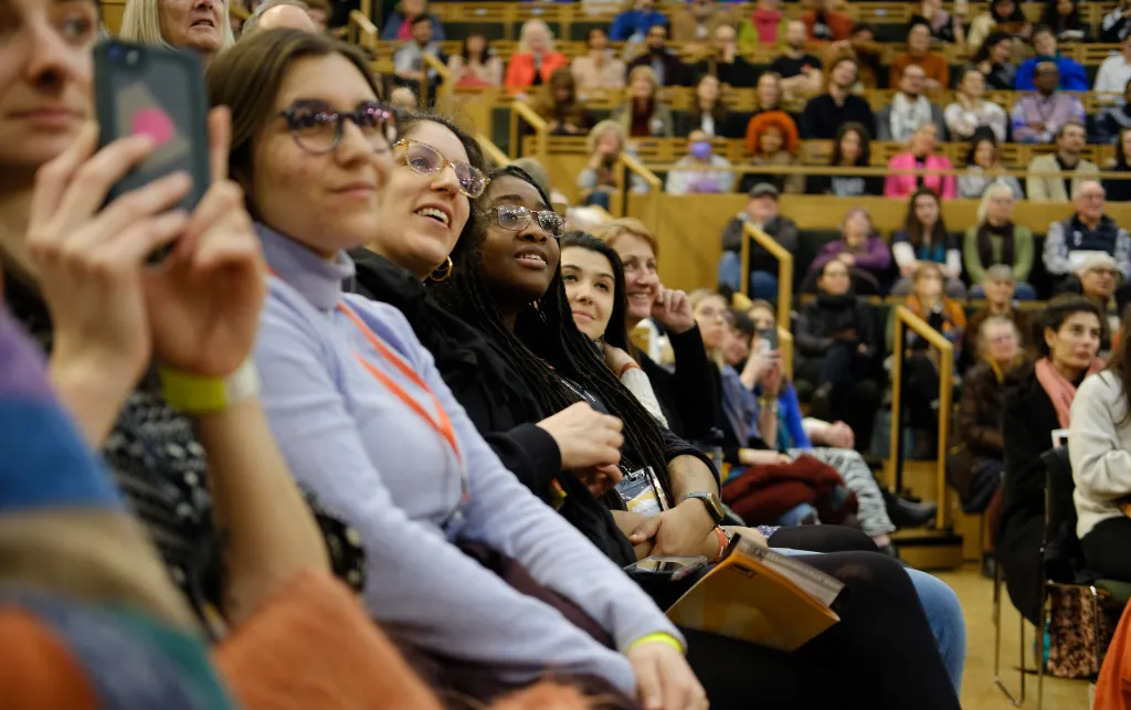 Crowds of people in the auditorium at 'And Still We Rise' festival