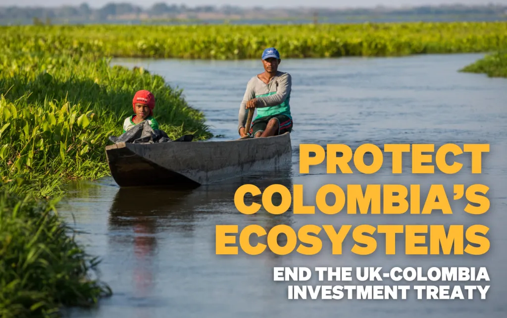Man and boy travel in a small boat on the water, surrounded by greenery