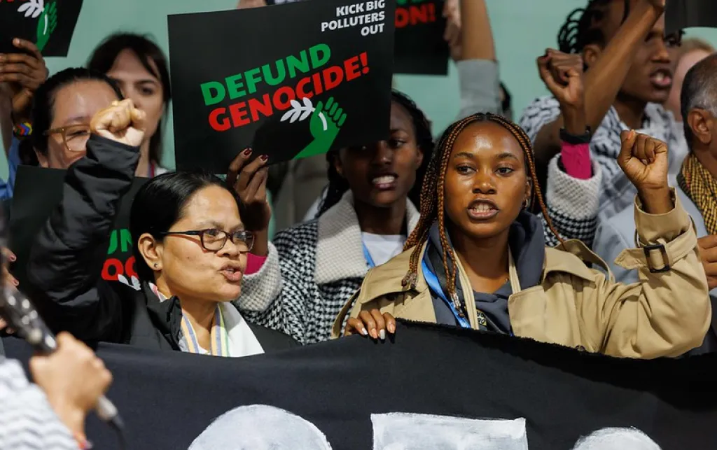 Protestors holding banners at COP29