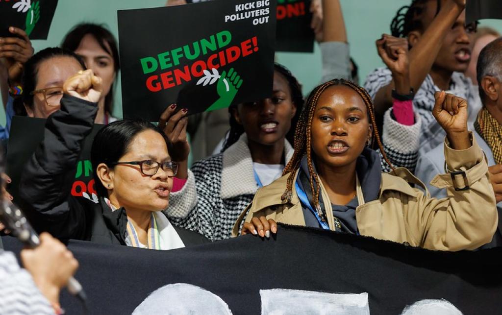 Protestors holding banners at COP29