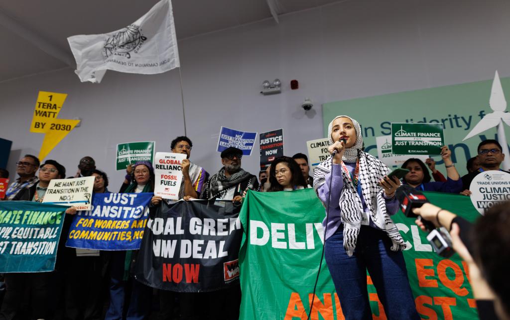 People holding banners during a protest at COP29