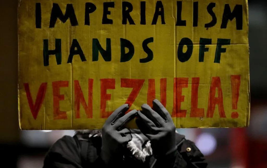 Banner saying 'IMPERIALISM HANDS OF VENEZUELA'