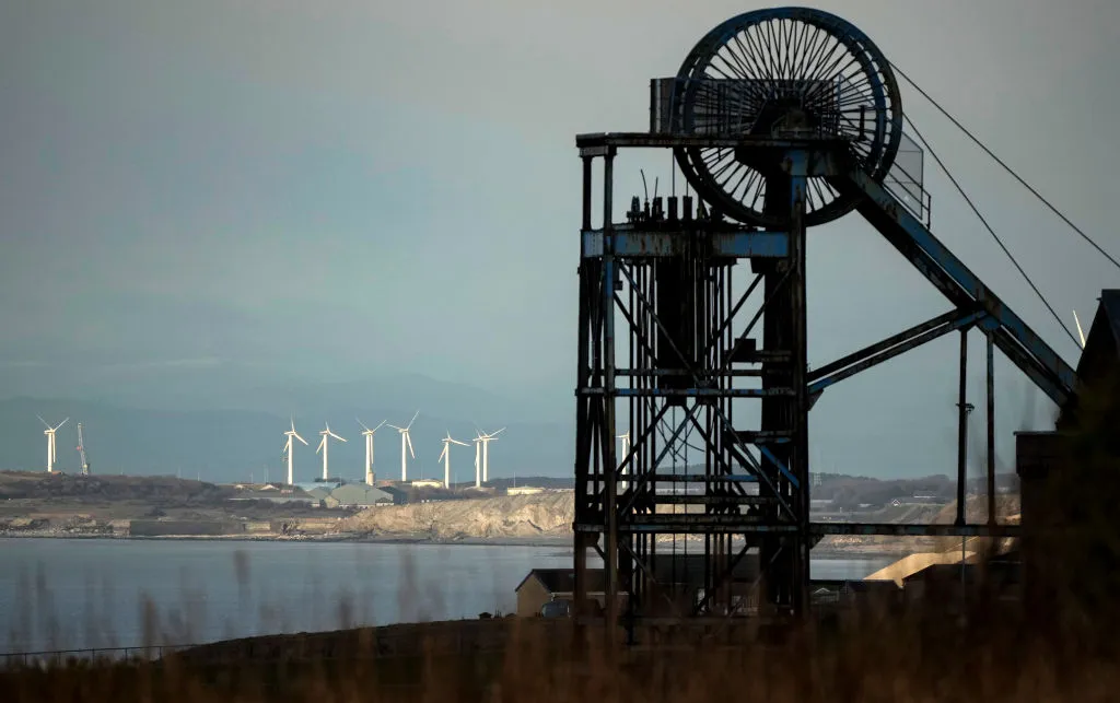 Black machinery, windfarm in background