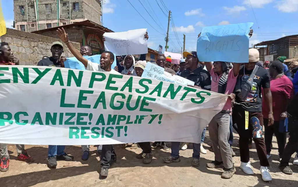 People marching through a street holding signs 