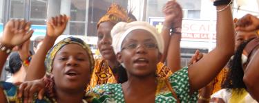 Francia Marquez and other Black women raise fists in the air. 