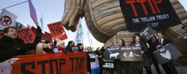 A demonstration to 'Stop TTIP', with a giant inflatable wooden horse and a banner on it that reads "TTIP: The Trojan Treaty".