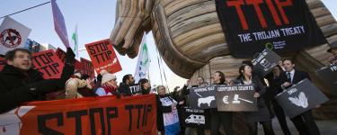 A demonstration to 'Stop TTIP', with a giant inflatable wooden horse and a banner on it that reads "TTIP: The Trojan Treaty". 