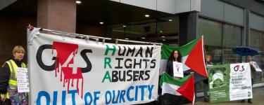 Protestors hold Palestine flags and a large banner that says "G4S: Human Rights Abusers out of our city".