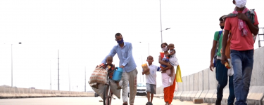 An Indian family walking with masks on. Image: From BBC News Video https://www.bbc.com/news/av/world-asia-52776442