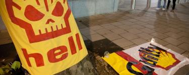 Vigil at the Shell Centre, London, on the 17th Anniversary of Ken Saro-Wiwa and the Ogoni 9. A banner has the Shell logo as a skull and reads "hell". Another banner has the word "Guilty" over the Shell logo. Photo: Martin LeSanto-Smith 2012