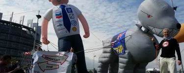 A TTIP protest in Strasbourg featuring giant inflatable figures of a 'corporate man' and his 'TTIP attack dog'.