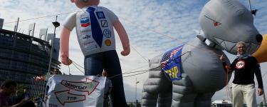 A TTIP protest in Strasbourg featuring giant inflatable figures of a 'corporate man' and his 'TTIP attack dog'.