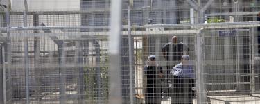 Palestinians walk through the gates of Ofer Military Court and Prison. Photo: Oren Ziv/Activestills