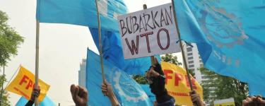 Jakarta, Indonesia. 6th Dec, 2013. Indonesian workers hold placards during a protest against trade liberalization, deregulation and privatization on the final day of the World Trade Organization (WTO) 9th Ministerial Conference outside the U.S. Embassy in Jakarta, Indonesia, Dec. 6, 2013. Credit: Agung Kuncahya B./Xinhua/Alamy Live News