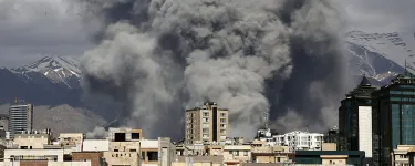 Buildings with grey smoke clouds behind