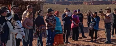 People standing in the middle of a desert during a protest against extractivism.