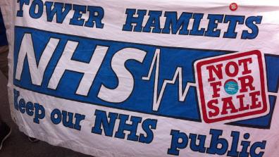 A banner at a demonstration that reads: "Tower Hamlets – NHS Not for sale: Keep our NHS public"