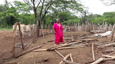 Eneida, standing in what's left of of her home, after it was destroyed by Cerrejon in September, 2017