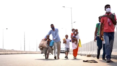 An Indian family walking with masks on. Image: From BBC News Video https://www.bbc.com/news/av/world-asia-52776442