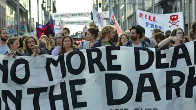 Protest in Brussels against the TTIP and CETA free trade agreements. Protesters hold a banner that says "No more deals in the dark. TTIP game over." Photo: M0tty
