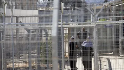 Palestinians walk through the gates of Ofer Military Court and Prison. Photo: Oren Ziv/Activestills