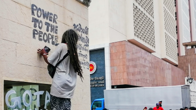 Sri Lanka protestor graffitis 'power to the people'