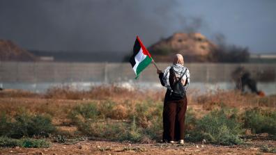 Women holding Palestiniain flag at apartheid wall