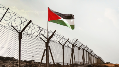 Palestinian flag behind barbed wire