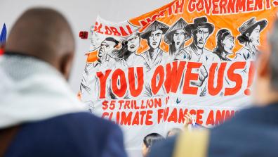 An orange and white banner that has the text "You owe us!" written on it,