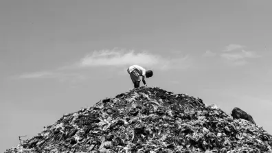 Photo of a person atop a mountain of clothes