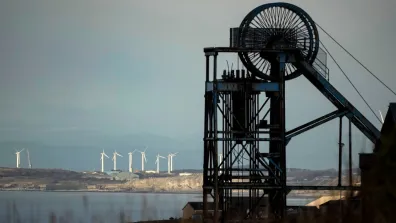 Black machinery, windfarm in background