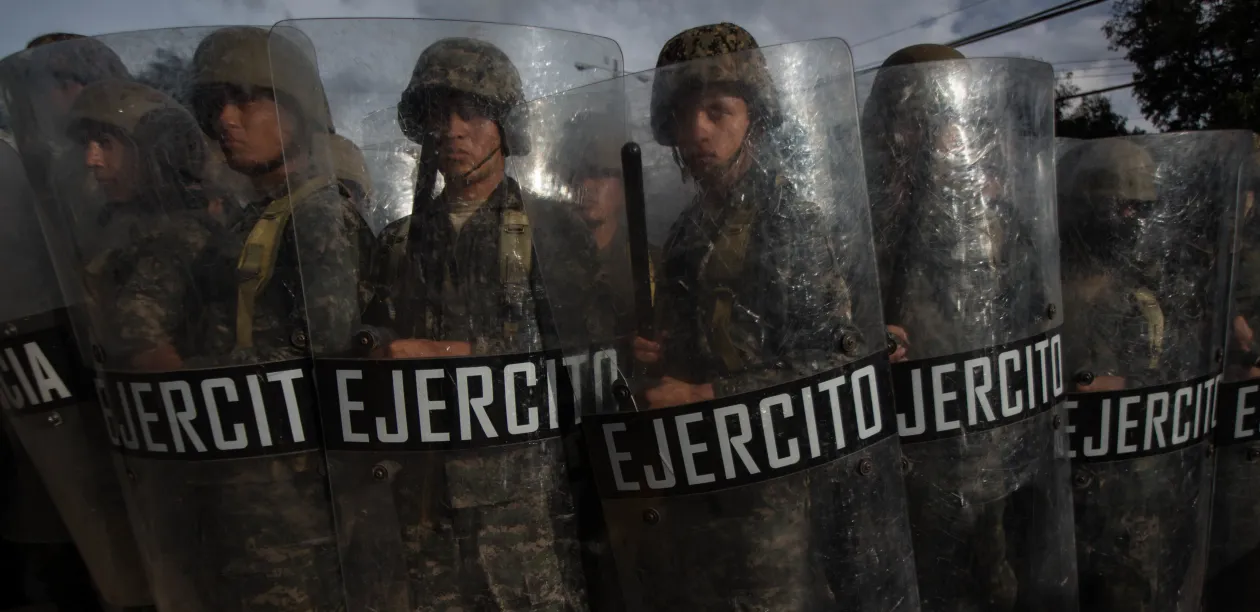 A row of Honduran military holding riot shields during 2017 elections. Photo: Sean Hawkey