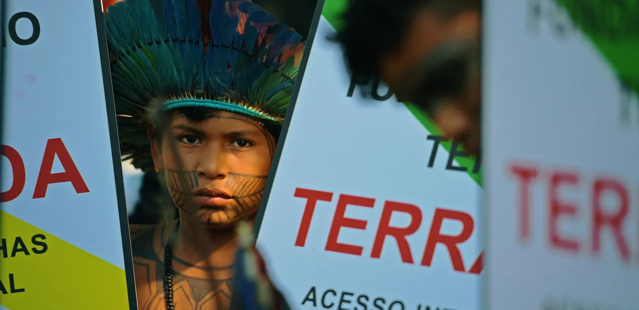 Indigenous Brazilian boy looks at the camera at a protest